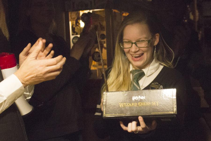 Kat Peters wins a Harry Potter chess set for having the best costume. The London Underground in downtown Ames hosted a Harry Potter-themed night to raise money for the Ames Public Library Friends Foundation (APLFF) on Nov. 15.