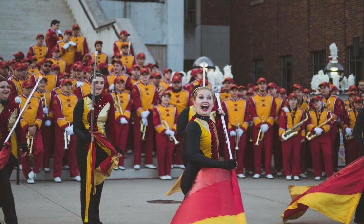 There is nothing that matches the feeling of being on the field after pregame [performance] when those sirens go off and the whole stadium just roars with excitement, said Shelby Robinson, junior in Iowa State Marching Band.