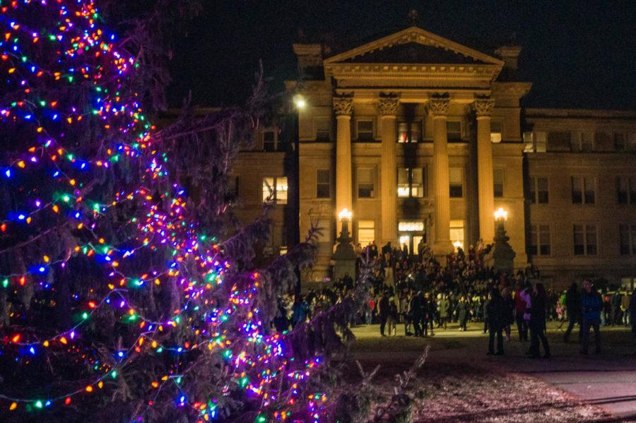 Students crowd around Beardshear hall to view the newly lit holiday tree during Winterfest on Nov. 30.