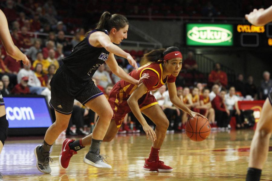 Junior Nia Washington looks for a teammate to pass the ball to during the game against the Winona State Warriors at Hilton Coliseum on Nov. 4. The Cyclones won 73-39.