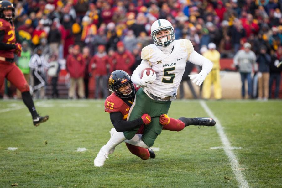 Redshirt Junior Defensive Back Braxton Lewis tackles Senior Wide Receiver Jalen Hurd during the first half of the Iowa State vs Baylor football game Nov. 10.