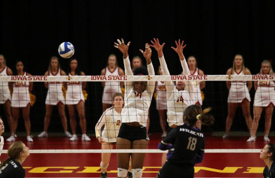 Middle blocker Grace Lazard (left) and outside hitter Jess Schaben (right) jump to block the ball during the Iowa State vs. Kansas State volleyball game at Hilton Coliseum on Oct. 26. The Cyclones won 3-1.