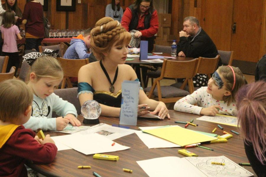 Children from the Ames community color and play with their favorite Ice Princess at Winterfest in the Pioneer Room of the Memorial Union on Nov. 30.