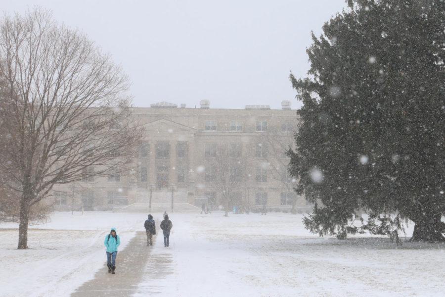 Students walk between Curtiss and Beardshear halls during a snowstorm on Jan. 11. Despite a 12-hour winter weather advisory, the university remained open.
