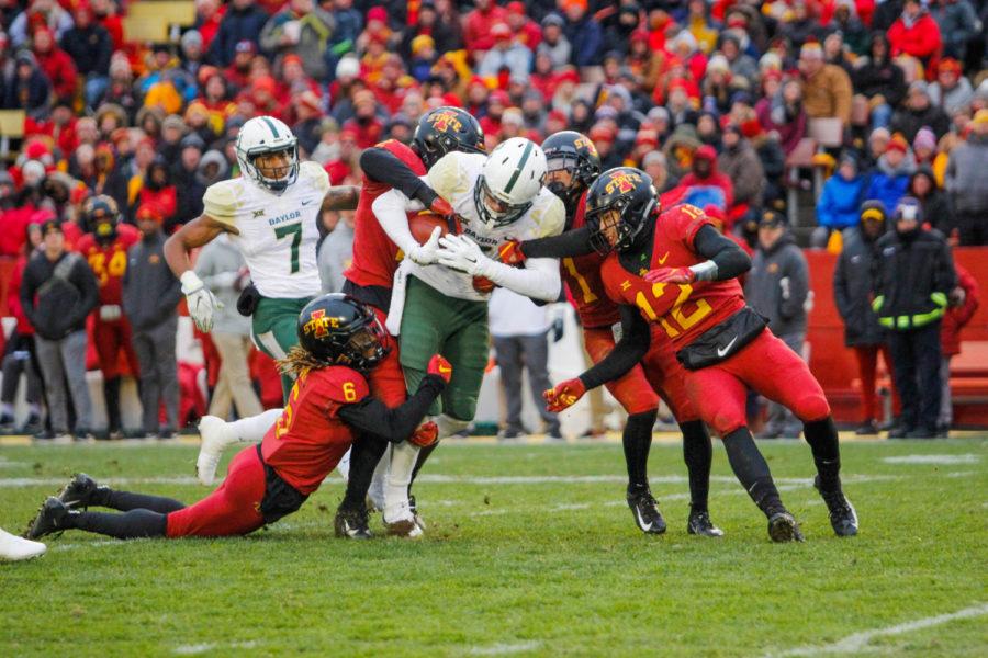 The Cyclones drag down a Baylor Bear during their game against Baylor on Nov. 10 at Jack Trice Stadium. The Cyclones finished the first half 17-0 against the Bears.