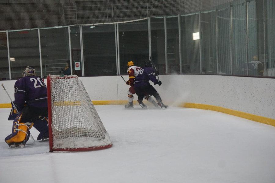 Freshman Alex MacDonald fights for the puck during the Cyclone Hockey versus McKendree University game on Nov. 30. The Cyclones lost to the Bearcats 5-2.
