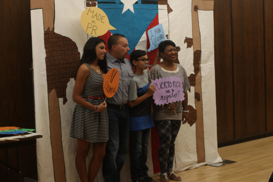 Families pose with signs relating to Puerto Rican culture at Puerto Rico Culture night in the Memorial Union on Oct. 22.
