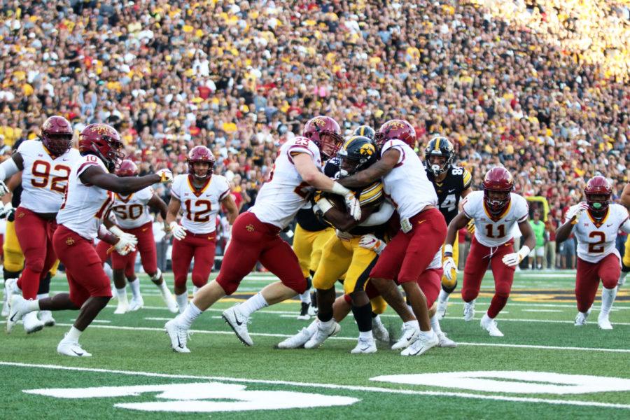 Linebacker%2C+Mike+Rose+%28left%29%2C+and+Defensive+back%2C+D%E2%80%99Andre+Payne+%28right%29+tackle+a+member+of+the+University+of+Iowa+football+team+during+the+game+against+University+of+Iowa+at+Kinnick+Stadium+on+Sept.+8.+The+Cyclones+were+defeated+13-3.