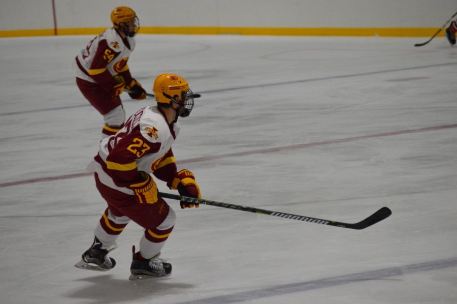 Joey Marcuccilli, #23 on the Cyclone Hockey team looks for the pass at Friday nights game. The game was held at the Ames/ISU Ice Arena. The Cyclones won the game against Minot State with a final score of 3-1. 