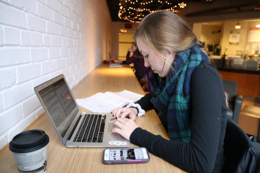 Sophomore Emily Gilbertson finds a warm place to study in Lagomarcino Hall November 12 drinking some coffee.