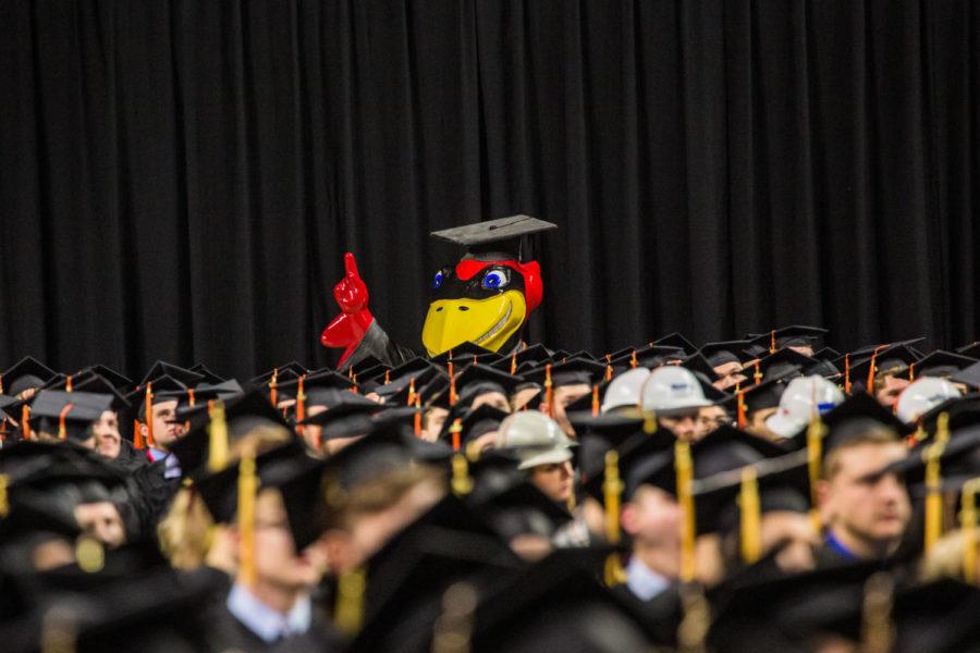 Cy the cardinal, dressed in a graduation cap and gown, looks over the graduating seniors during fall 2018 graduation on Dec. 15.