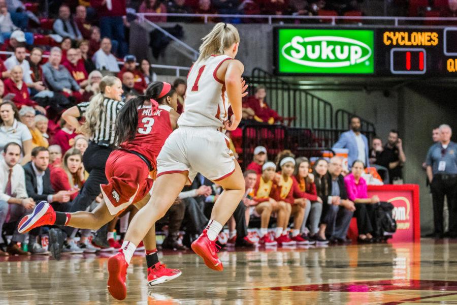 ISUs Madison Wise sprints back on to defense alongside Arkansas Malica Monk during the Cyclone/Razorback game on Dec 2 at Hilton Colosseum. Cyclones won 91-82.