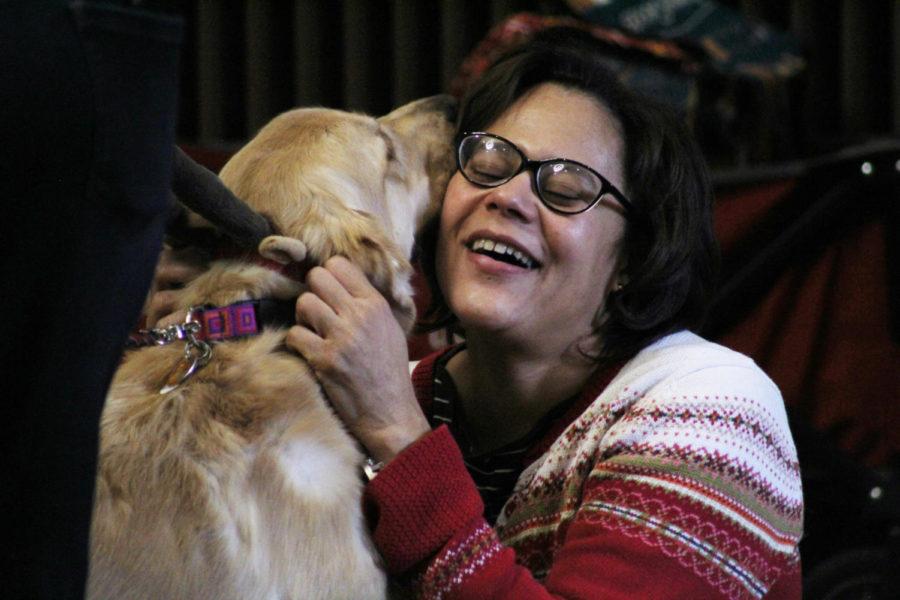 Junior in computer engineering, Eleni Vaskova, plays with certified therapy dog, Miley during Barks@Parks on Dec. 3. Barks@Parks is held daily during dead week in the upper rotunda of Parks Library, to help students reduce stress during the week.