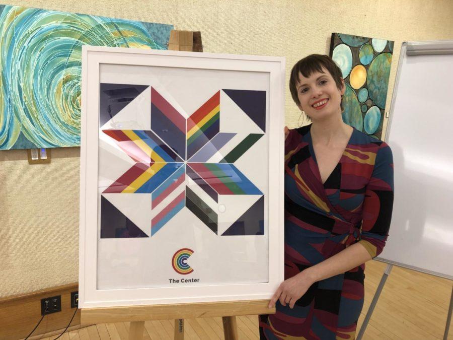 Dr. Clare Lemke receives a framed barn quilt made out of LGBTQIA+ flags at her farewell reception.