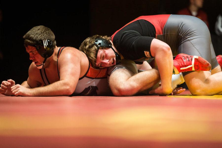 Redshirt sophomore Gannon Gremmel wrestles Tommy Helton during the Iowa State vs SIU-Edwardsville match in Stephens Auditorium Nov. 11. The Cyclones won nine of the 10 matches over the Cougars.