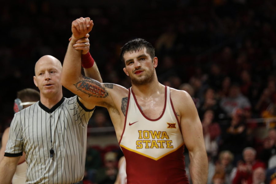 Willie Miklus of Iowa State has his arm lifted in victory after defeating Oklahomas Jake Woodley.