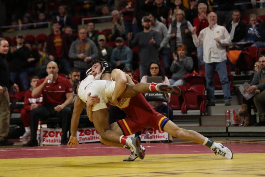 Iowa States Ian Parker throws Oklahomas Dom Demas scores a takedown in overtime that didnt count as stalling was called against Demas seconds prior. The stalling point gave Parker the win, 4-3.