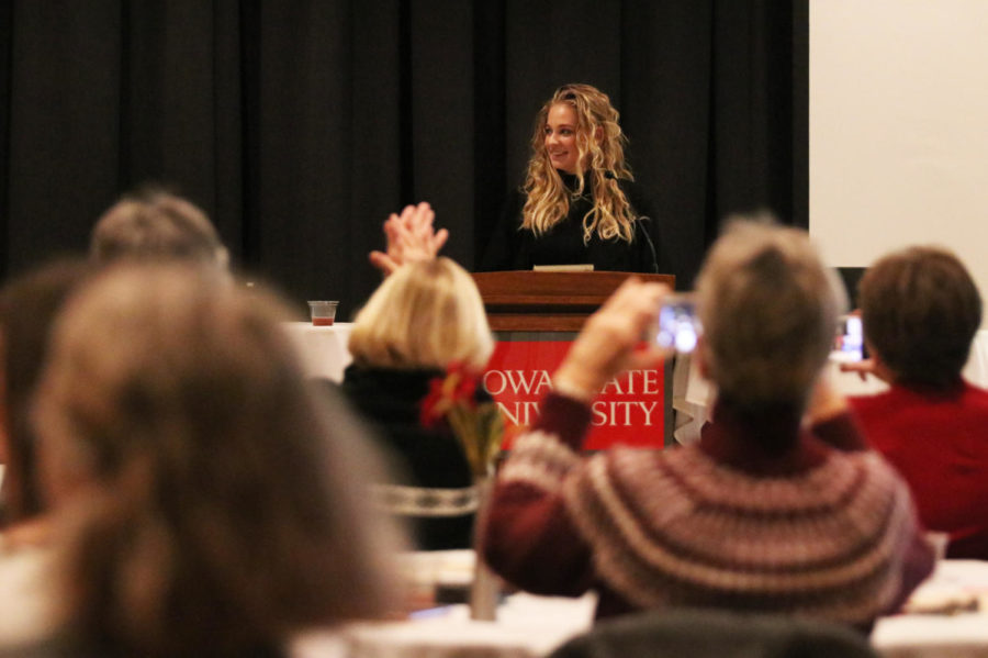 Grace Tuzik, public relations and events planning intern for the Carrie Chapman Catt Center for Women and Politics, reads out the names of Women Impacting ISU 2019 calendar honorees during a reception held in the Sun Room of the Memorial Union on Jan. 16. Twelve women from Iowa State were selected to appear in the calendar.