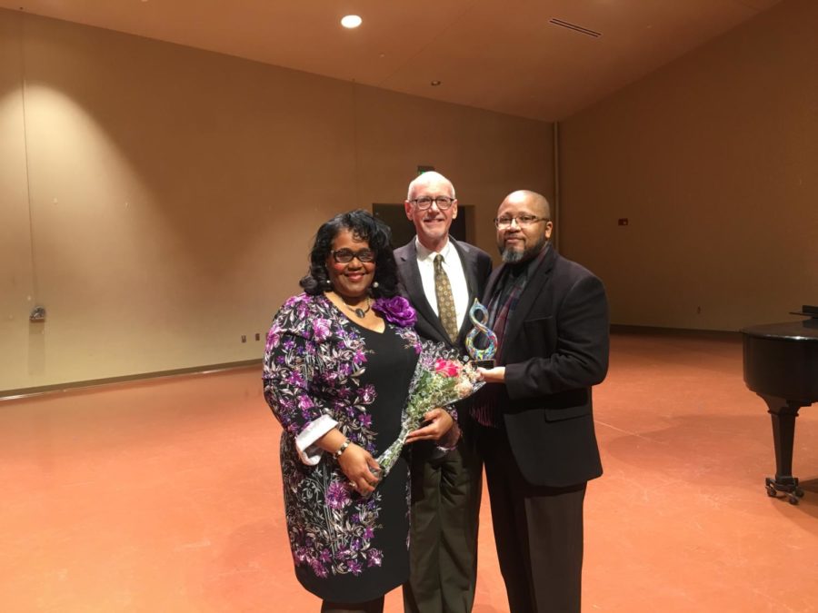Iowa State Vice President for Diversity and Inclusion Reginald Stewart (right) holds his award beside Mayor John Haila and Renee Harman. 