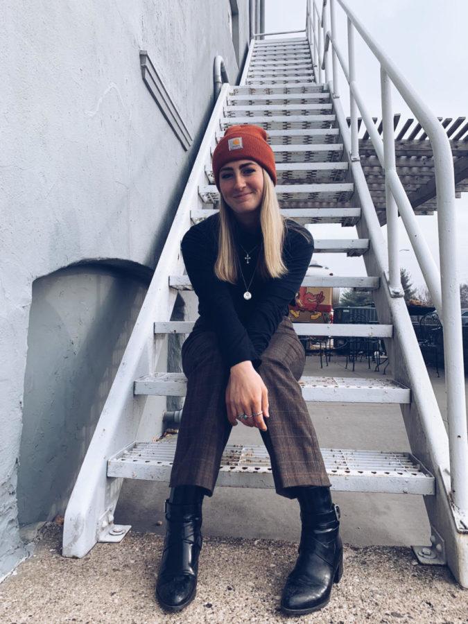 Sarah Wright, senior studying apparel, merchandising and design, thrifted most of the outfit pictured including her Carhartt hat, which was found for $3 at an outdoors store.