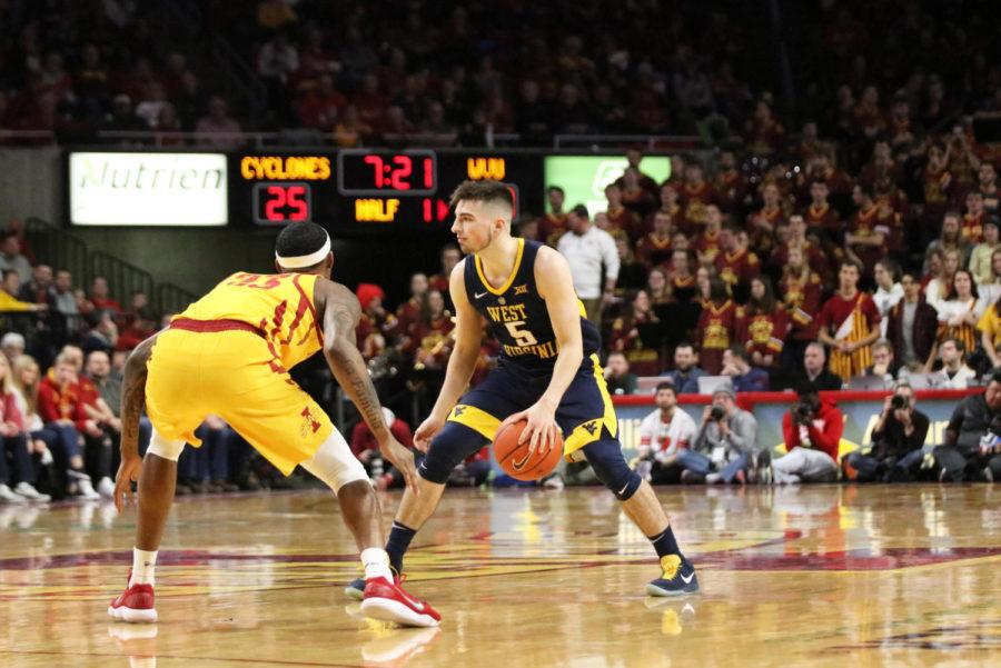 West Virginia freshman Jordan McCabe faces off against Iowa State senior Zoran Talley Jr. during the basketball game at Hilton Coliseum on Jan. 30. The Cyclones ended the half with a lead over West Virginia. The Cyclones won 93-68.