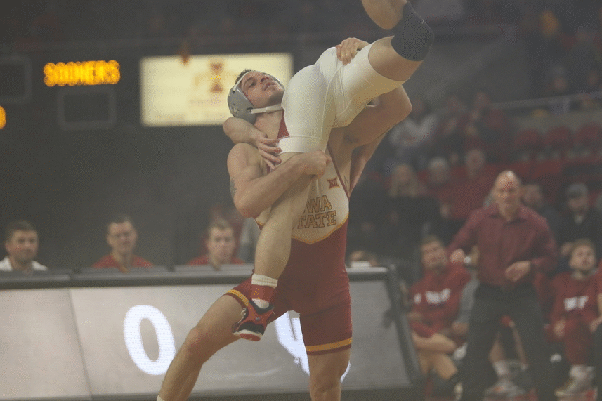 Iowa+State+125+pounder+Alex+Mackall+throws+Oklahomas+Christian+Moody+in+the+first+match+of+the+meet+on+Friday.+Mackall+defeated+Moody%2C+10-4.