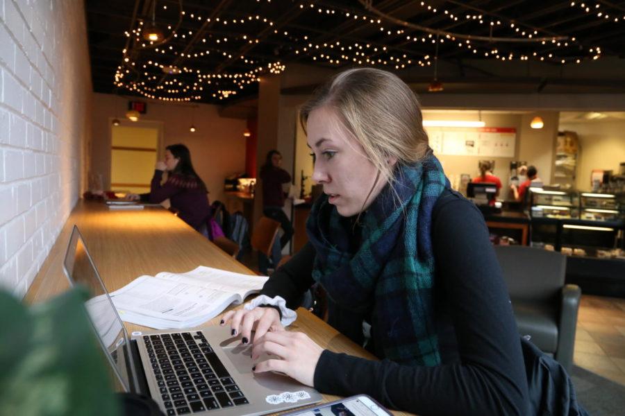 Sophomore Emily Gilbertson finds a warm place to study in Lagomarcino Hall November 12 drinking some coffee.