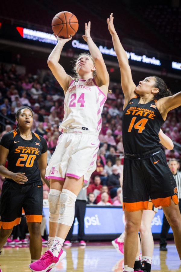 Iowa State freshman guard Ashley Joens attempts a two-pointer while guarded by Oklahoma State sophomore guard Braxtin Miller during the first half of the Iowa State vs Oklahoma State women’s basketball game held in Hilton Coliseum Feb. 16. The Cyclones defeated the Cowgirls 89-67.