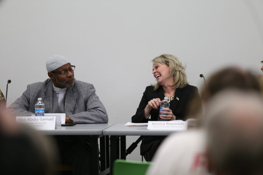 Jessica Reynolds, Story County Attorney, and Ako Abdul-Samad, legislator and founder of Creative Visions, share a moment on the Iowas Stand your Ground Law Panel. The panel was held Thursday at the Ames Public Library.