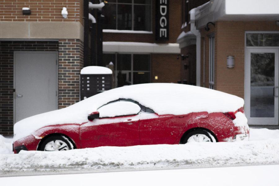 A car sits snowed in on Lincoln Way. There was 6.2” of snow by the morning which breaks the 2015 snowfall record. 