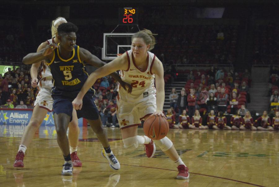 Iowa State then-freshman Ashley Joens blocks West Virginia University then-redshirt junior Tynice Martin on her way to the basket during the third quarter of the game at Hilton Coliseum on Feb. 9. The Cyclones won 77-61 against the Mountaineers.