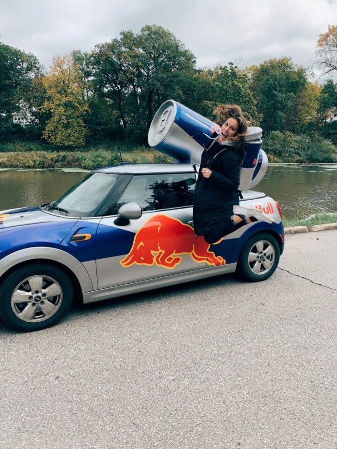 Maura Frenchs, a sophomore in event management, duty is to advertise Red Bulls products in different areas while decked out in Red Bull gear and riding in style with a Red Bull Mini Cooper.