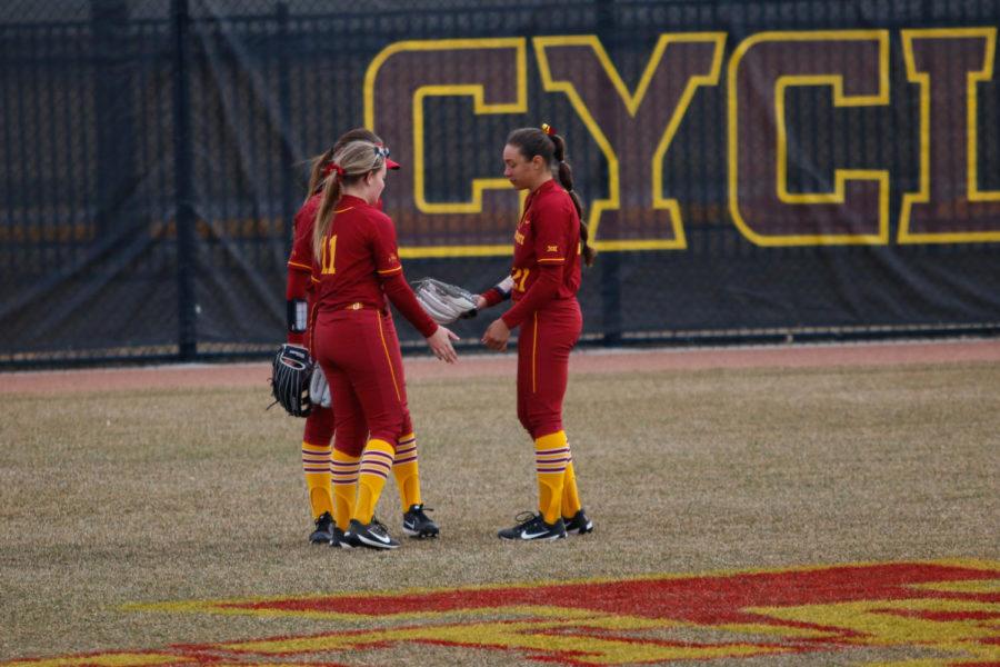 Iowa State outfielders Bryn Hanrahan, Kaila Konz and Taylor Nearad high five each other during the Cyclones 11-4 loss to Texas.
