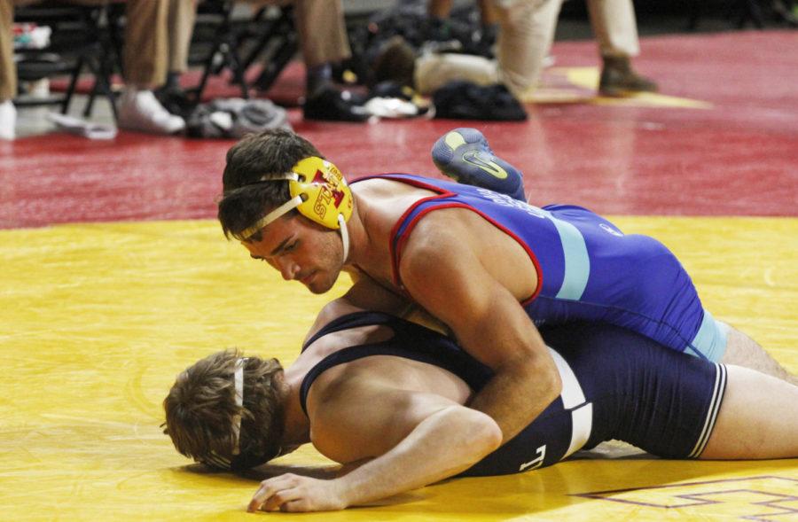 Freshman Logan Schumacher takes on another wrestler during the Harold Nichols Cyclone Open Nov. 3 in Hilton Coliseum. 52 schools competed during this tournament.