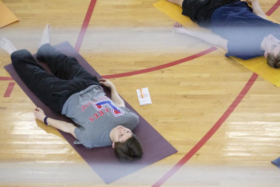 Freshman in computer engineering William Blanchard practices a deep relaxation exercise at Yogathon. “I have never been to a Yoga event here before but for my first real experience with it, it was very enjoyable, said Blanchard. The Yogathon grand finale was held in the east basketball court at State Gym on Feb. 9.