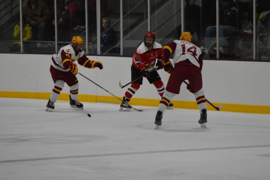 Nick Rogers #14, and Adam Alcott #15, on the Cyclone hockey team against Minot State at Friday nights game. The game was held at the Ames/ISU Ice Arena. The Cyclones won the game against Minot State with a final score of 3-1. 