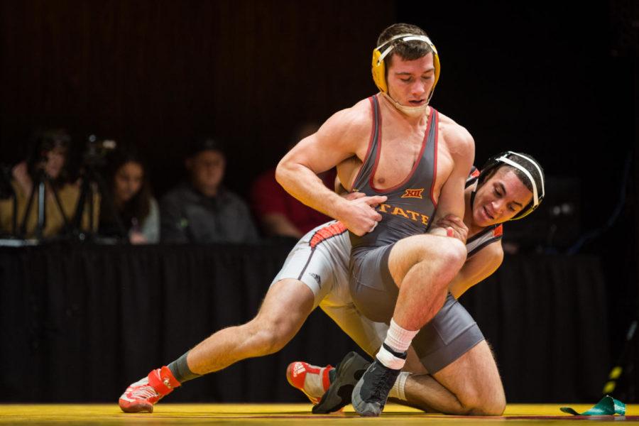 Redshirt junior Chase Straw wrestles Justin Ruffin during the Iowa State vs SIU-Edwardsville match in Stephens Auditorium Nov. 11. The Cyclones won nine of the ten matches over the Cougars.