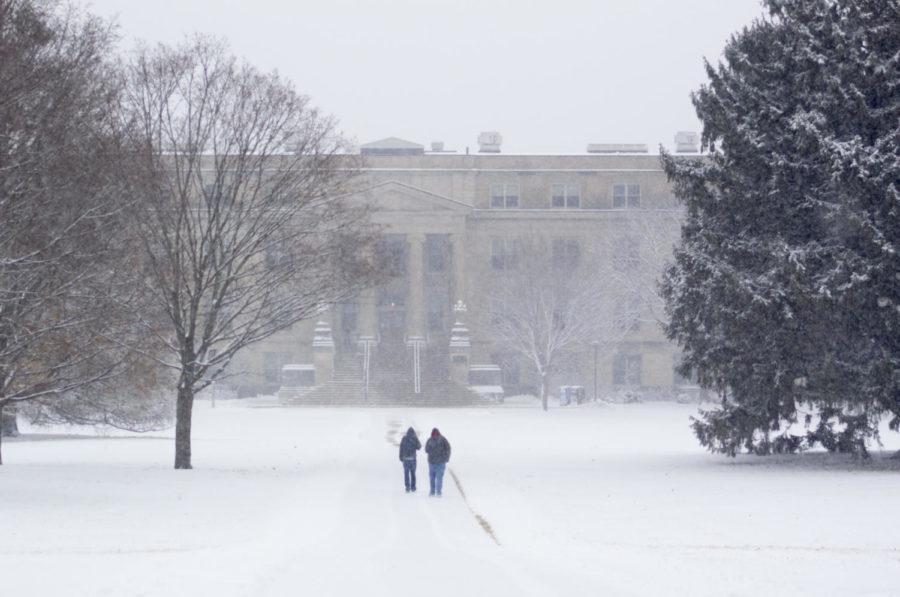 Brave souls walk the path between Curtis and Beardshear as snow falls across Ames and the Iowa State campus Jan. 12. By the end of the day, the total snowfall was 2.5 inches.