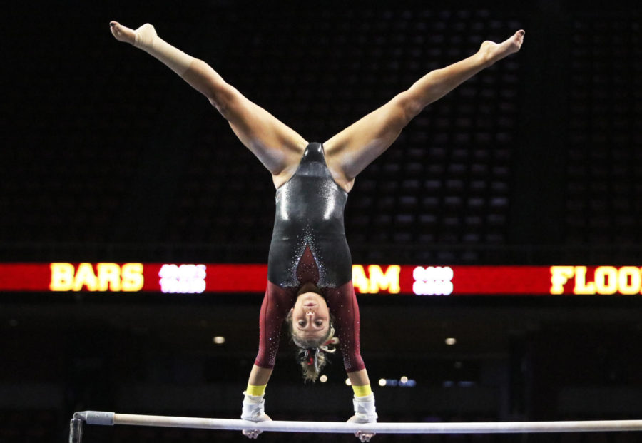 Iowa State gymnast Laura Burns competes during the bars competition at the gymnastics meet against Southern Utah University at Hilton Coliseum on Feb. 8. Burns scored a 9.900 during the bars competition. Iowa State won with an all-around score of 195.375, beating out Southern Utah with a score of 195.250. Iowa State had higher scores then Southern Utah in vault, bars, beam and floor.