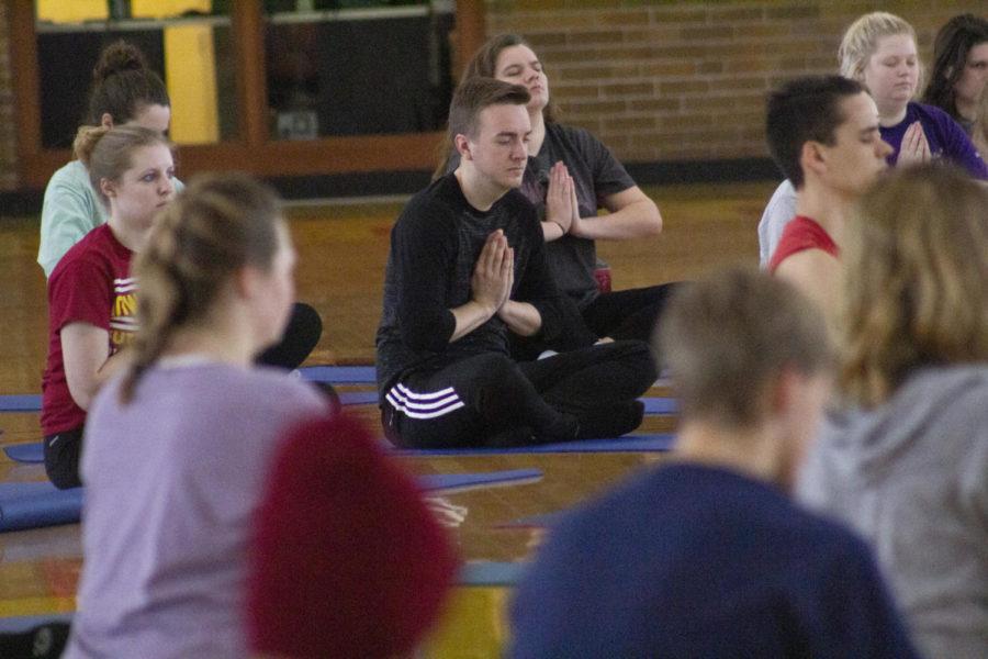 Senior in interior design Hayden Cole practices a deep relaxation exercise at Yogathon. Yogathon was put on by Yoga Club and Hindu Yuva on Feb. 9.