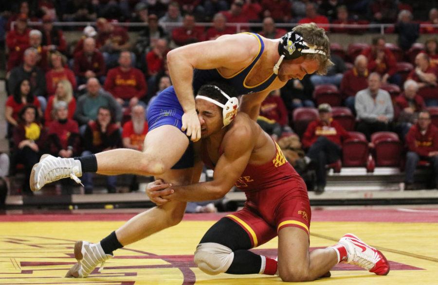 Iowa State redshirt freshman Marcus Coleman takes on South Dakota State redshirt freshman Samuel Grove as a part of the 174-pound weight class during first period of their match at Hilton Coliseum on Feb. 1. Coleman won the match up. The Iowa State wrestling team won 47-0 against South Dakota State.