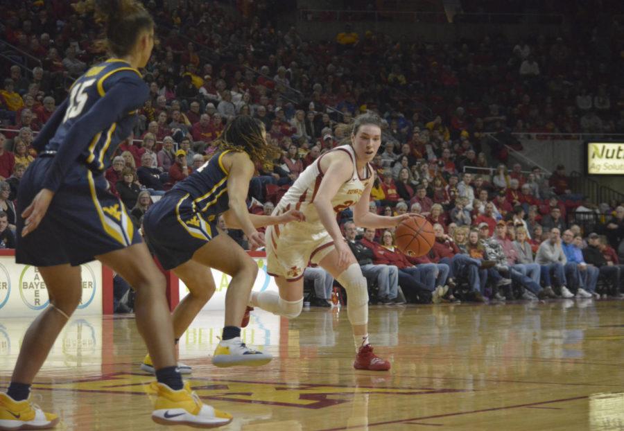 Iowa State senior Bridget Carleton defends the ball against West Virginia University junior Lucky Rudd (left) and freshman Kari Niblack (middle) during the last seven minutes of the fourth quarter. West Virginia University freshman Kari Niblack received her fourth foul during this play. The Cyclones won 77-61 against the Mountaineers.