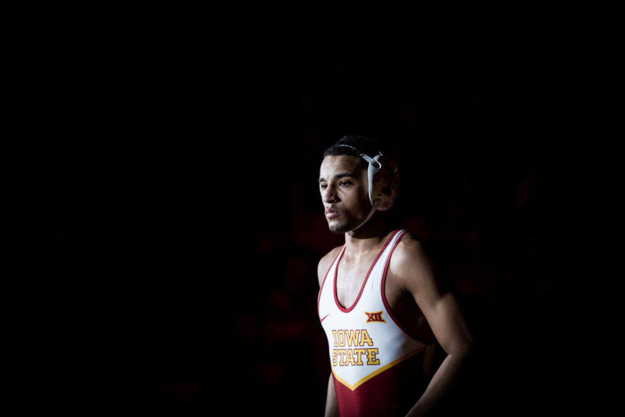 Redshirt freshman Marcus Coleman walks on to the mat for his 174-pound match up against redshirt freshman Kyle Snelling during the Iowa State vs Utah Valley dual meet Feb. 3 in Hilton Coliseum. Coleman won by technical fall 17-2 and the Cyclones defeated the Wolverines 53-0.