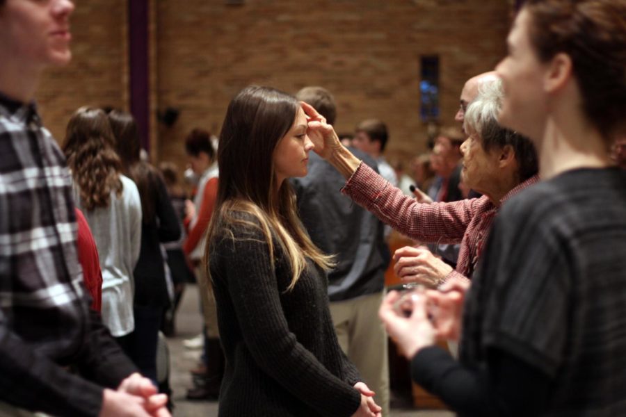 A parishioner receives ashes on her forehead during Ash Wednesday mass March 1, 2017, at St. Thomas Aquinas Catholic Church. Ash Wednesday marks the beginning of the season of Lent for Christians.