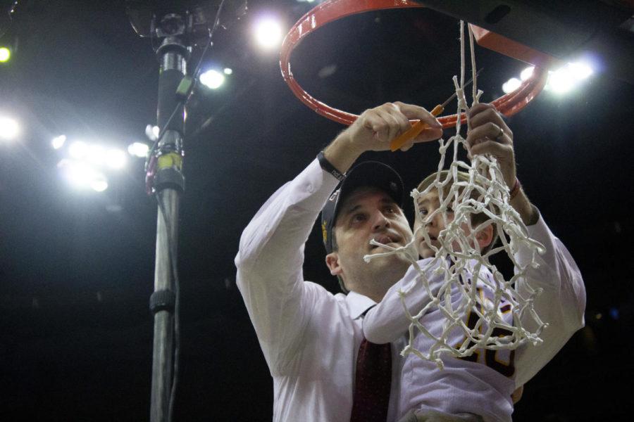 Head+coach+Steve+Prohm+holds+his+son+Cass+Prohm+as+he+cuts+down+the+last+part+of+the+net+to+keep+as+a+memento.+Iowa+State+won+the+Big+12+Championship+78-66+against+University+of+Kansas+on+March+16+at+the+Sprint+Center+in+Kansas+City%2C+Missouri.
