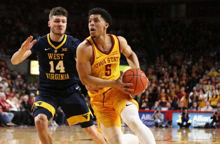 Iowa State sophomore Lindell Wigginton makes his way towards the basket while being guarded by West Virginia junior Chase Harler in the second half during the game at Hilton Coliseum on Jan. 30. The Cyclones won 93-68.