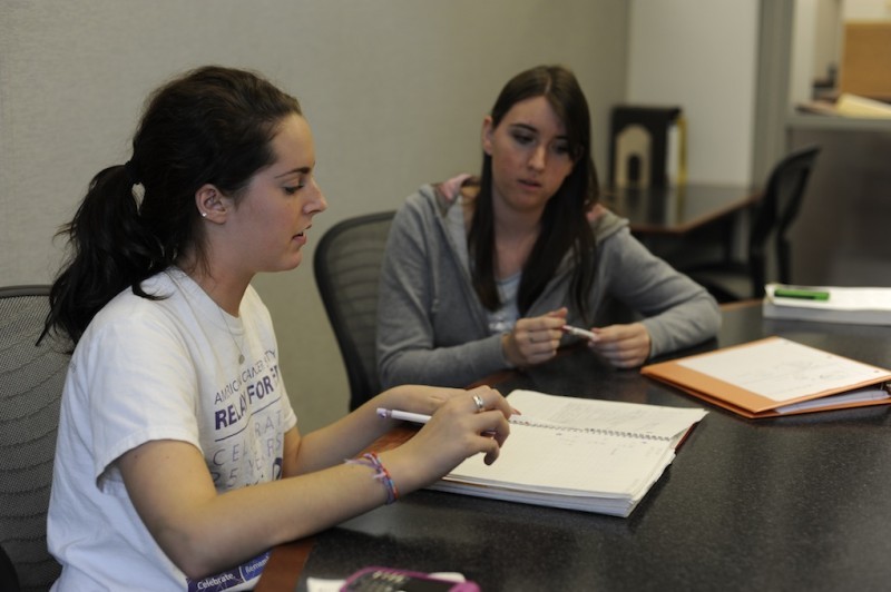 Emily Kienzle sophomore in English, right, tutors Meredith Keeler freshman in Spanish, in math at studio 4 in Parks Library. 
