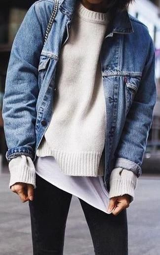 Layering a sweater and denim jacket over leggings is an effortless way to prepare for unpredictable weather. 