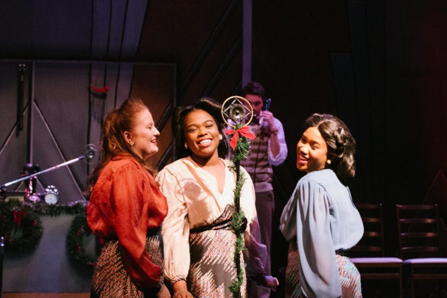Joi Wright (center) performs during an onstage performance.