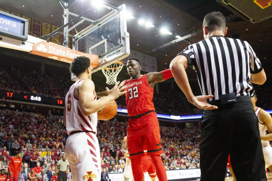 Sophomore+guard+Lindell+Wigginton+looks+to+pass+the+ball+past+Texas+Tech+redshirt+senior+center+Norense+Odiase+during+the+first+half+of+the+senior+night+game+against+Texas+Tech.+The+Cyclones+lost+80-73+against+the+Red+Raiders+on+March+9+at+Hilton+Coliseum.%C2%A0